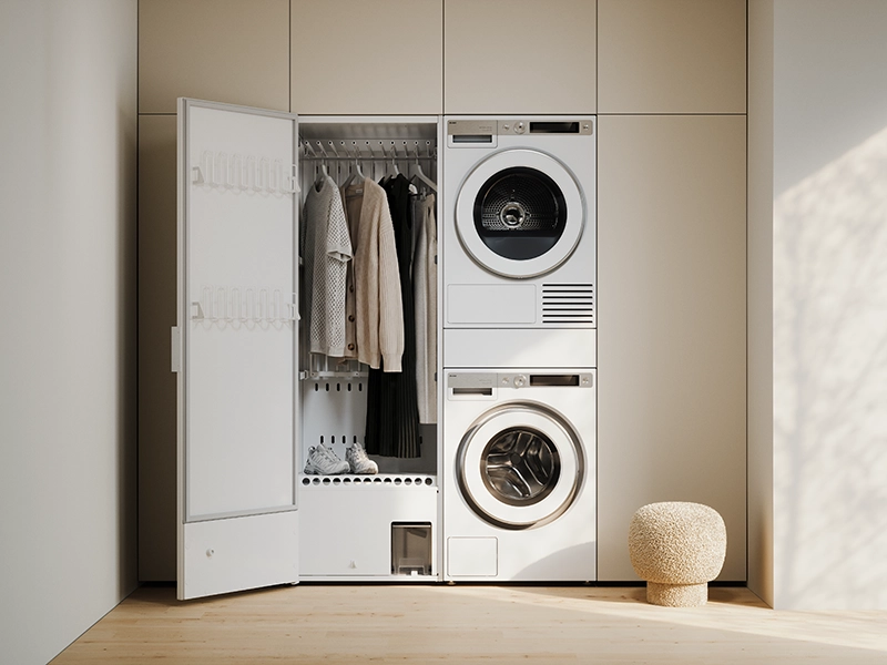 ASKO heat pump drying cabinet integrated beside a stacked washer and dryer in a modern laundry space. ASKO heat pump drying cabinet integrated beside a stacked washer and dryer in a modern laundry space.