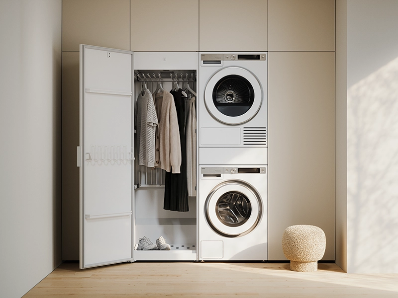ASKO vented drying cabinet installed beside a stacked washer and dryer for efficient garment drying. ASKO vented drying cabinet installed beside a stacked washer and dryer for efficient garment drying.