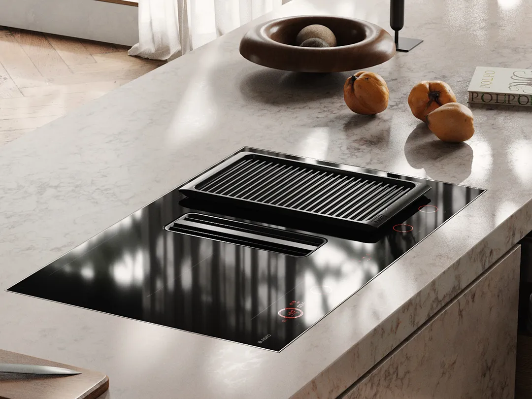 ASKO hood in hob with a grill plate, installed in a light stone kitchen island.
