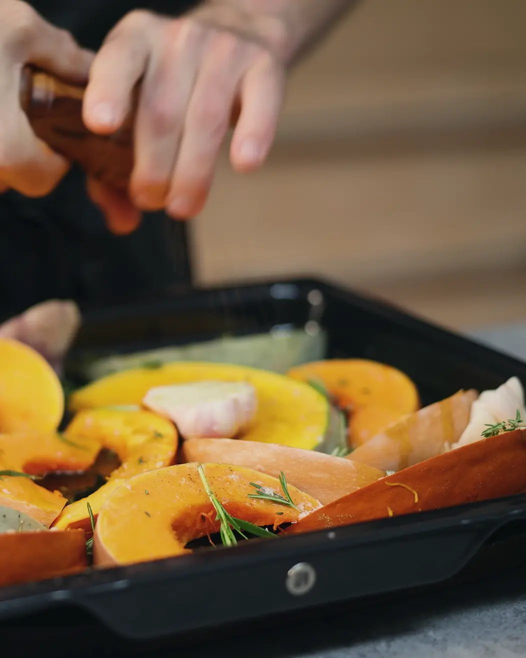Pumpkins being prepared on an oven tray to be roasted Pumpkins being prepared on an oven tray to be roasted
